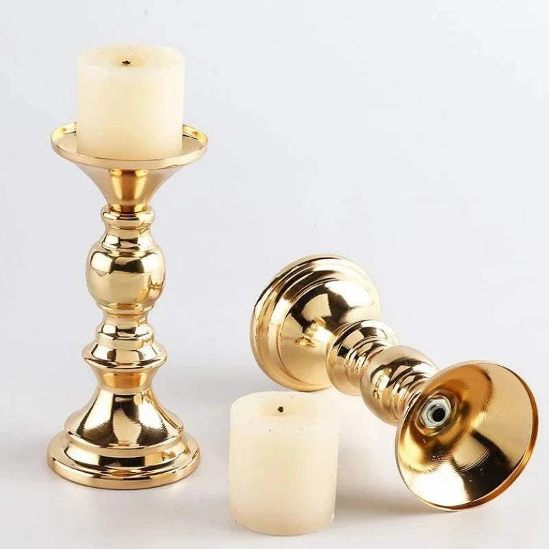 Elegant golden metal candle holders with cream-colored pillar candles for wedding and home decor