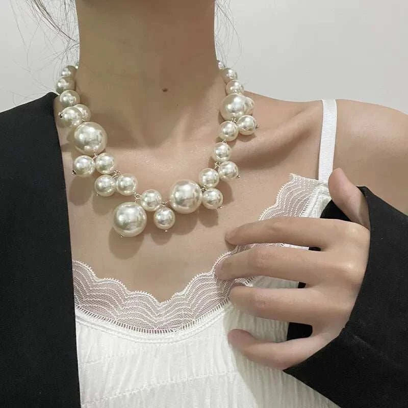 Women wearing elegant imitation pearl necklace with large round beads choker style perfect for weddings and parties